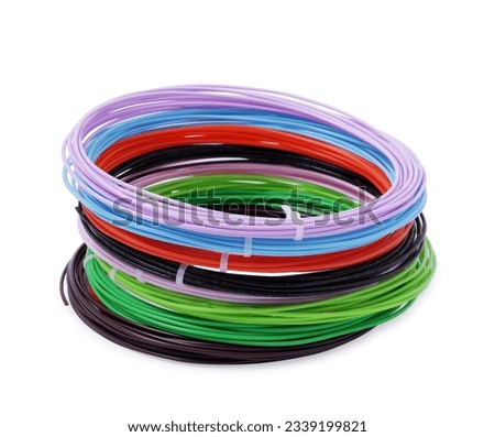 Stack of colorful plastic filaments for 3D pen on white background
