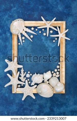 Oyster pearl and seashell abstract with white shells on mottled blue background with gold frame. Nature design with exotic and tropical varieties.