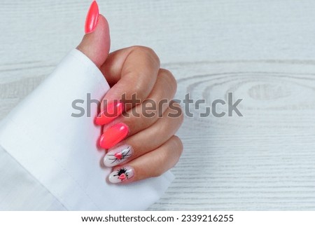 Close-up photo of women's hands with an elegant manicure. Glamorous beautiful manicure with strawberry