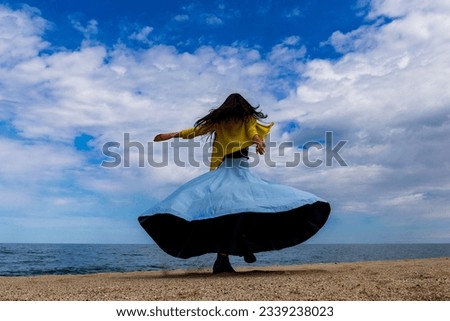the image of a happy woman running to the sea, an image that gives a sense of freedom