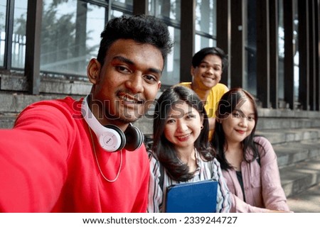 POV of Multicultural college students having fun taking selfie picture smiling using smartphone