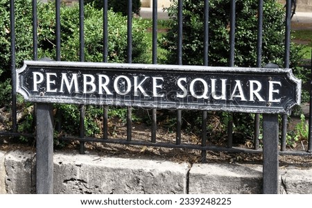 A photograph of a street sign for 'Pembroke Square'