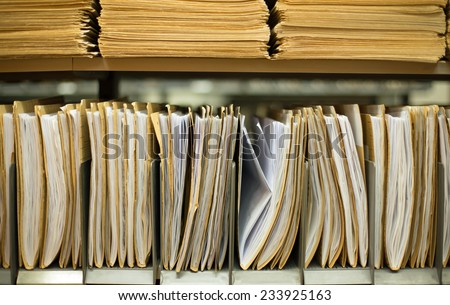 Shelf with file folders in a archives Royalty-Free Stock Photo #233925163