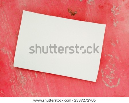 A single blank white paper is placed on a pink vintage wall. Best mockup for advertisement purposes.