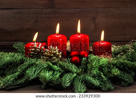 advent decoration with four red burning candles. holidays background. selective focus, vintage style toned picture