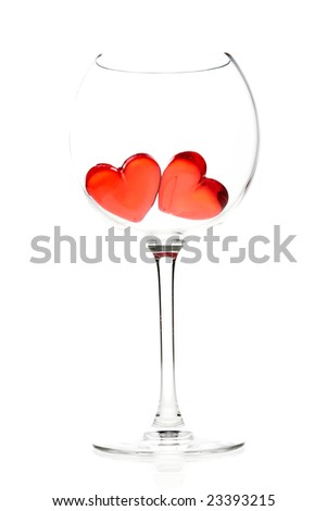 two red jelly hearts in wine glass over white background