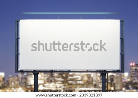 Blank white horizontal billboard on city buildings background at night, front view. Mockup, advertising concept