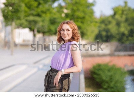 Beautiful middle aged woman posing on the street photo shoot