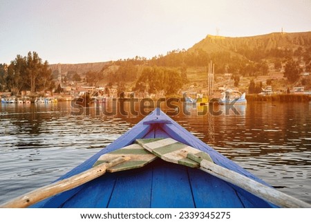 wooden boat tip and colors on a lake at sunset in bolivia hispanic america