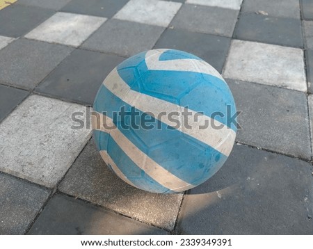 blue and white plastic ball on paving block