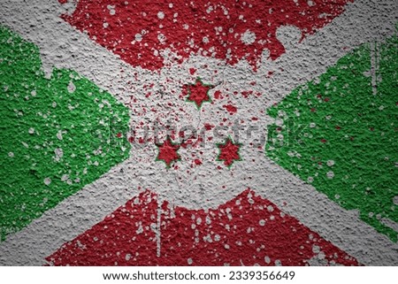 colorful painted big national flag of burundi on a massive old cracked wall