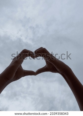 Put your hands together in a heart shape under the sky. If you look at it another way, it looks like a mini heart.