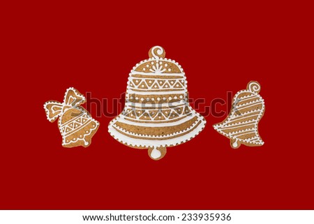 Homemade three bells gingerbread and honey cookies on nice christmas theme on red background.