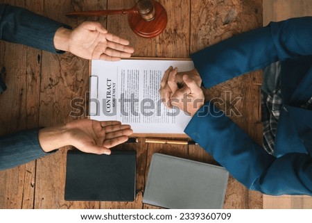 contract of sale was placed on the table in the lawyer office because the company hired the lawyer office as a legal advisor and drafted the contract so that the client could sign the right contract. Royalty-Free Stock Photo #2339360709
