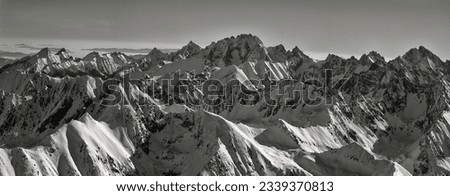 Black and white panorama of the High Tatras, snowy peaks in winter, aerial view. Slovak and Polish Tatras. Winter landscape.