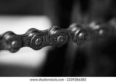 Detail of bicycle chain in black and white photo, chain and gears, gear wheel, old an oiled