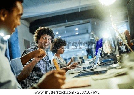 Young people working in a startup company office and using smart phones Royalty-Free Stock Photo #2339387693