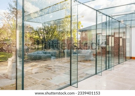Contemporary large family home with glass atrium  Royalty-Free Stock Photo #2339401153