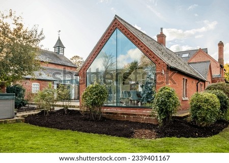 Contemporary large family home with glass atrium  Royalty-Free Stock Photo #2339401167