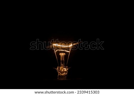 Electricity. Dark background. carbon arc on blackbackground. 
Vintage petro incandescent lamp. Royalty-Free Stock Photo #2339415303