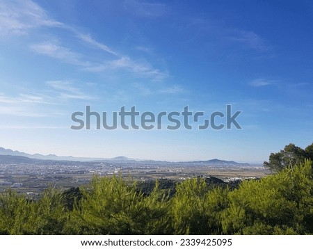 Panoramic view of the landscape in city of Tetouan, Morocco. The city is set against a backdrop of the Rif Mountains, and it is a beautiful sight to behold. The image is full of vibrant colors