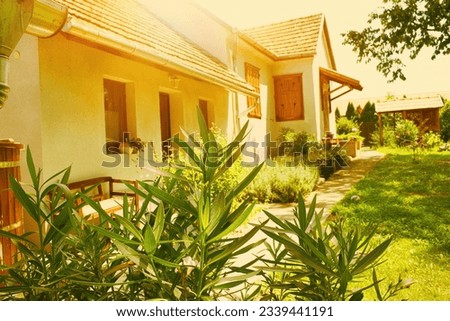 View of traditional house and garden.Summer season. High quality photo