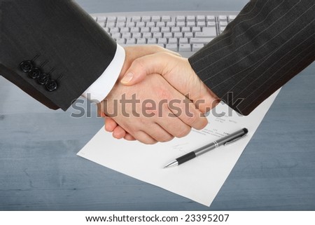 businessmen handshake over contract and pen