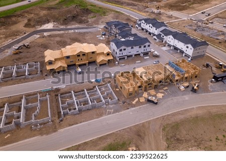 A new housing development is being built on the site of a new housing development. real estate and mortgage concept  Royalty-Free Stock Photo #2339522625