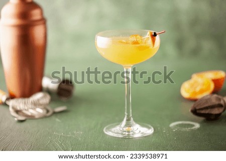 Boozy Corpse Reviver No 2 Cocktail with Gin and Lemon in Cocktail glass. Alcoholic drink and bar tools. Royalty-Free Stock Photo #2339538971
