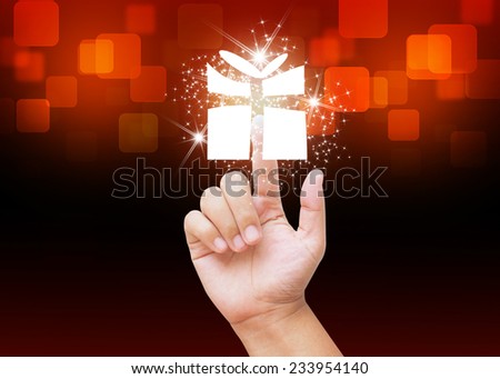 Hand pressing Christmas gift box buttons on holiday background