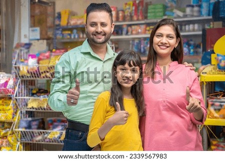 indian family showing thumps up at grocery shop. Royalty-Free Stock Photo #2339567983
