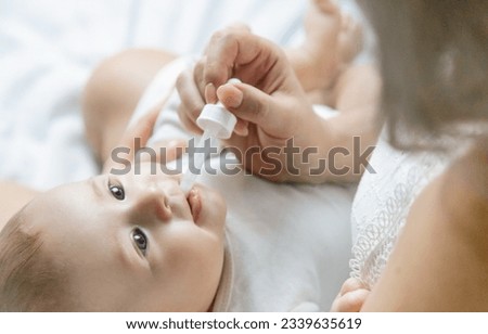 Mother gives medicine to baby for colic. Selective focus. People.