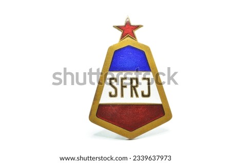 Badge from Socialist era, that shows Flag of Former Yugoslavia with red star on top  Royalty-Free Stock Photo #2339637973