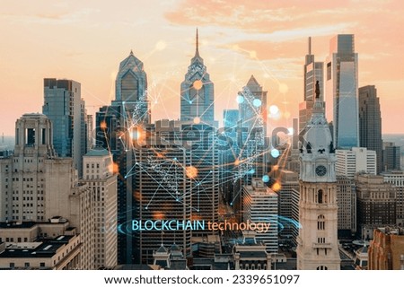 Aerial panoramic skyline of Philadelphia financial downtown, Pennsylvania, USA. City Hall Clock Tower at sunset. Decentralized economy. Blockchain, cryptocurrency and cryptography concept, hologram