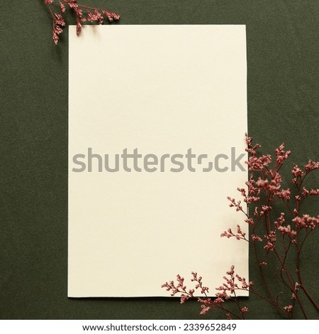 Blank greeting card, invitation and envelope mockup.  Happy mother's day, women's day or birthday, wedding composition. Minimal floral frame made of dry flowers and branches. Flat lay, top view.