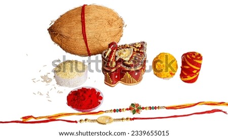 Indian brother and sister festival: Raksha Bandhan background with an elegant Rakhi, Rice Grains and Kumkum.
