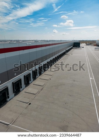 aerial drone view of  warehouse building with empty docks in distribution center 
