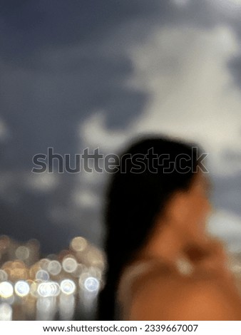 Blurred photo of a image of the women looking at the sky