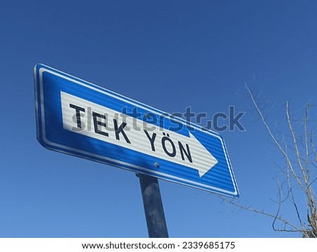 one way sign in the way with blue sky