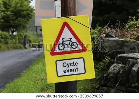 A caution sign on a rural road in Wales warning motorists of a cycle event.