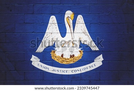 Flag of Louisiana painted on a cinder block wall. Royalty-Free Stock Photo #2339745447