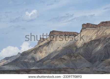 Book cliffs with a blue sky, great clouds, and dancing shadows