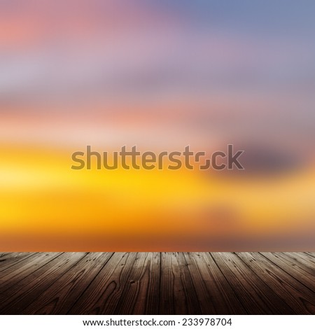 Background with wooden table and sunset over the sea