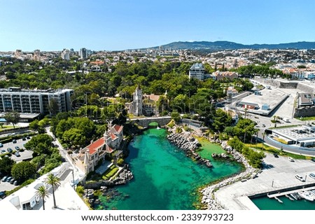 Cascais coastal resort town in Lisbon at sunny summer day, drone point of view of townscape. Turquoise waters of the Atlantic Ocean, rocky coastline. Travel, tourism concept. Portugal Royalty-Free Stock Photo #2339793723