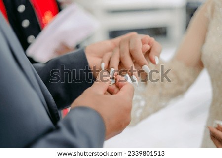 The exchange of wedding rings by the bride and groom. A "wedding ring" is a symbolic piece of jewelry worn on the finger, typically the ring finger of the left hand.