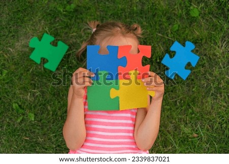 A color puzzle made of elements in the hands of a child suffering from autism syndrome. Brainteasers for the development and education of children Royalty-Free Stock Photo #2339837021