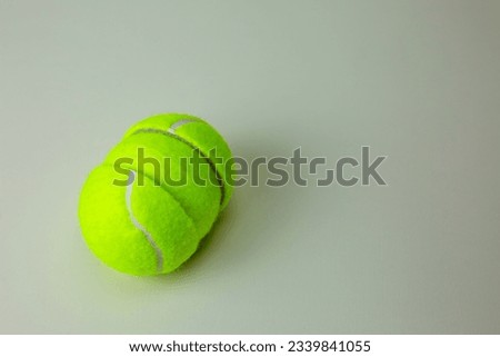 Tennis ball cut in half. The hemisphere of a rubber ball for sports is divided into two parts and a whole ball for tennis