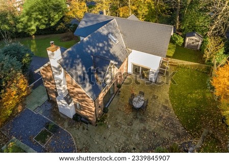 Aerial view of house with large garden in Autumn season