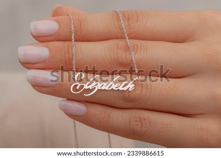 Silver necklace on a well-groomed lady. Product image that can be used in e-commerce, social media, online sales. Jewelry photo with woman jewelry concept.