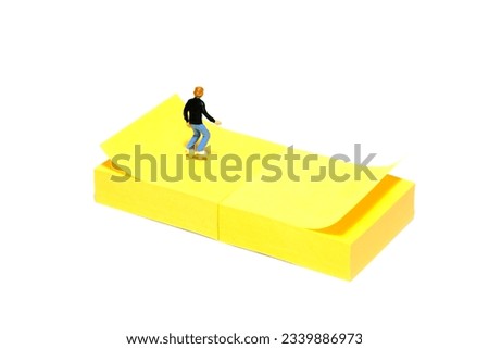 Creative miniature people toy figure photography. Sticky notes installation. A boy roller skater playing at skate park. Isolated on white background. Image photo